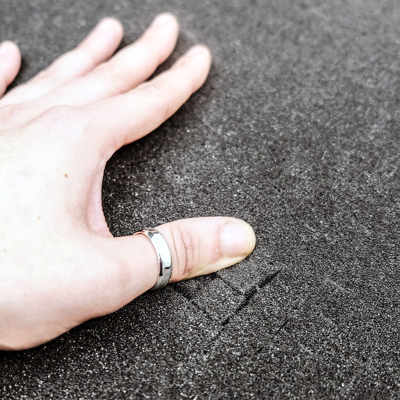 Hand pressing into Pick N Pluck foam insert showing cushioning and impact absorption