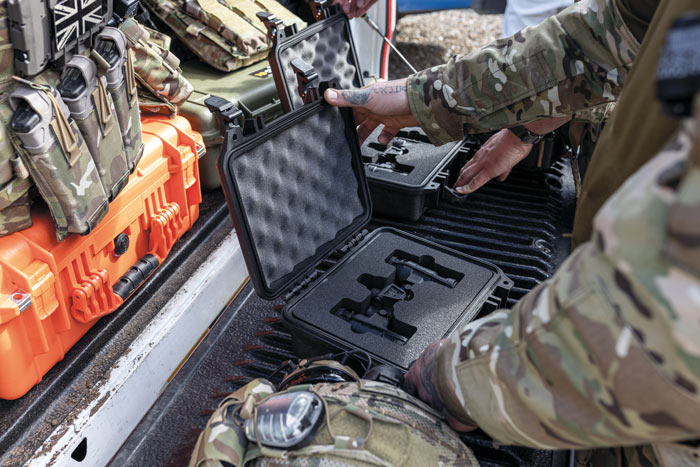 A black Peli case with custom foam being used to house military binoculars.